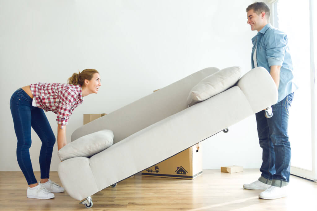 Portrait of pretty young couple moving in new home